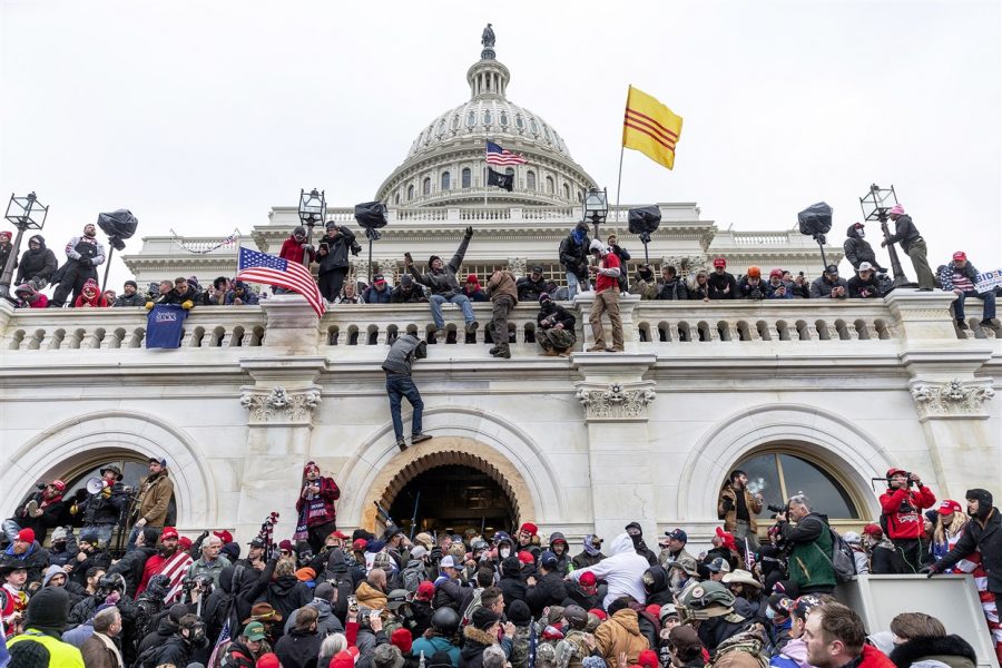 Rioters gather and climb the Capitols walls. (Photo credit: Lev Radin)