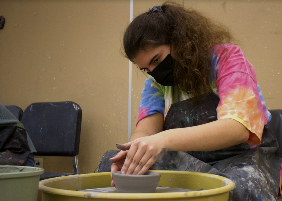 Michalena Capogreco (II) hones her pottery skills on the wheel.
