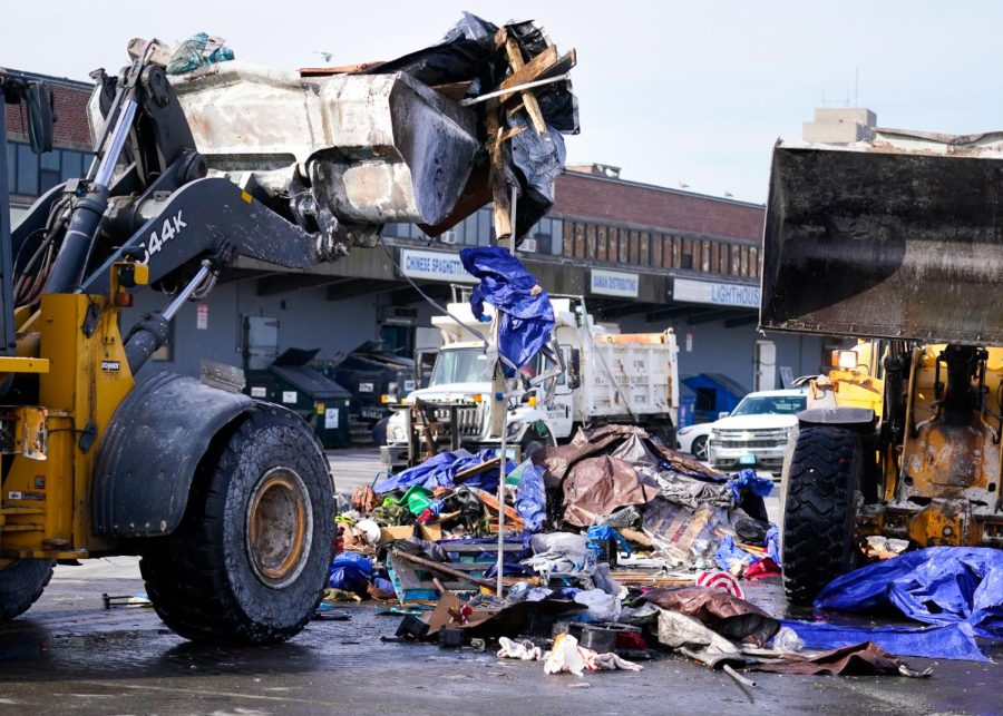 Public works employees bulldoze Mass and Cass residences. (Source: Rodrique Ngowi)