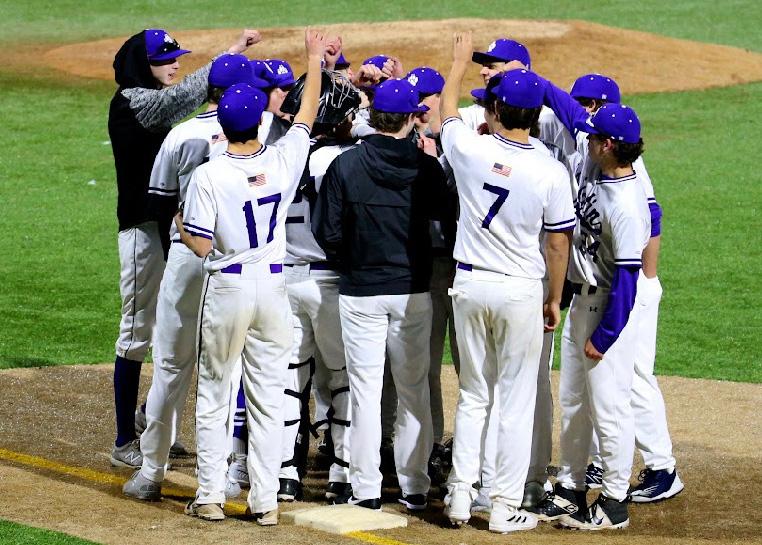 The BLS varsity baseball team huddles before a game. (Source: Lloyd Young)