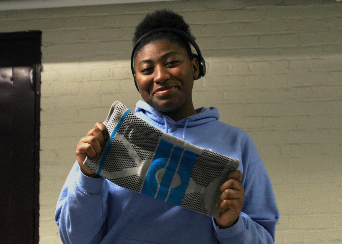 Cheerleader Gianni Wilkinson (II) shows off her lucky knee brace!
(Source: Sashia Flores (VI))