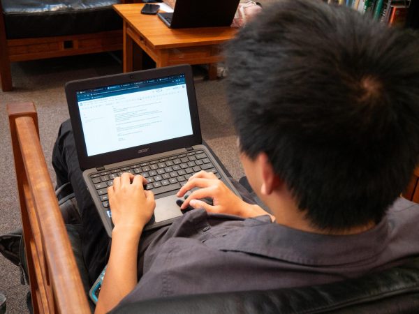 Track runner Matt Ouyang (II) completes his German homework before a meet.(Source: Alex Le (III))