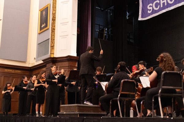  Mr. Anthony Morales leads the Concert String Orchestra in a fiery performance after months of hard work. (Source: Alex Le (II))