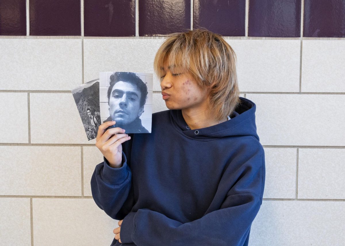 Timmy Truong (I) poses with pictures of the #HealthcareHottie. (Source: Sophia Knobel (III))