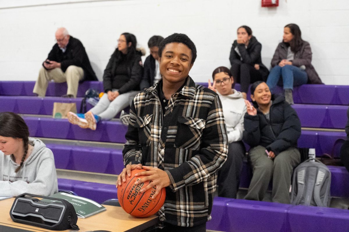 Girls’ varsity basketball team manager Donnell Davis (III) supports the team from the sidelines! (Source: Alex Le (II))