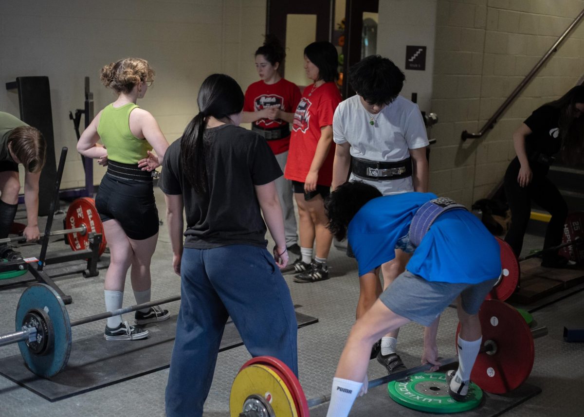 Lifting creates a positive environment as athletes spot one another. (Source: Alex Le (II))