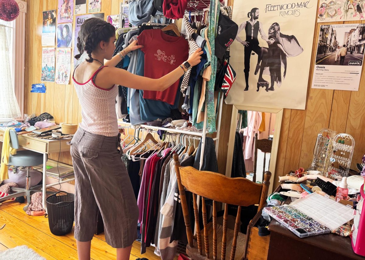 A student looks through clothes while wearing capris and polka dots. (Source: Abby Wilson (IV))