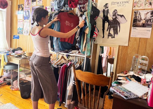A student looks through clothes while wearing capris and polka dots. (Source: Abby Wilson (IV))