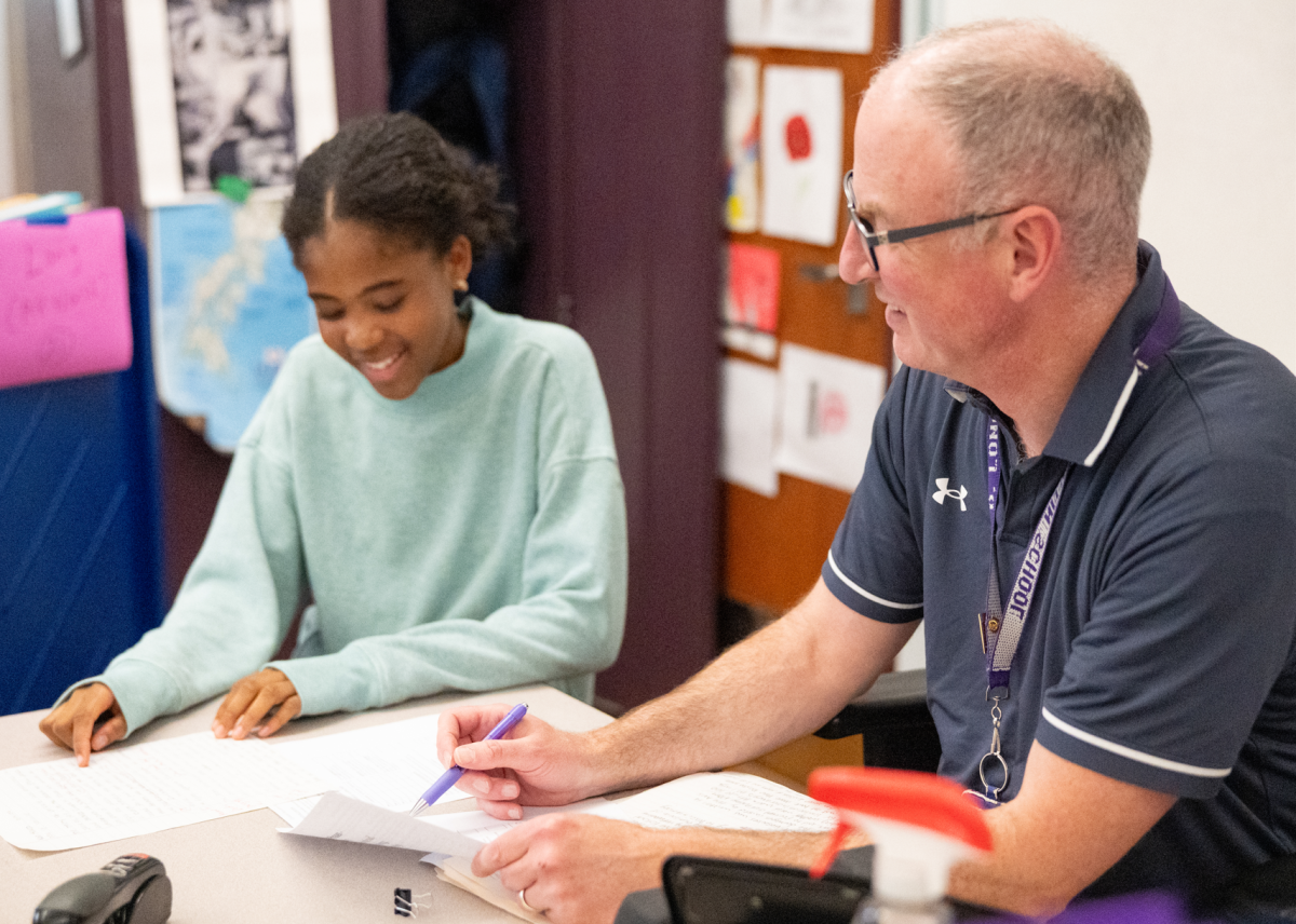 BLS history teacher Mr. David Long helps a student with their assignments. (Source: Kaiya Platt (IV))